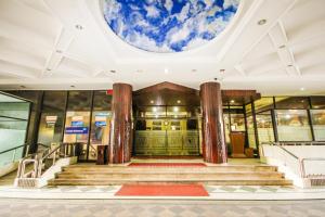 a lobby of a building with a round ceiling at Grand Menteng Hotel in Jakarta +9 photos
