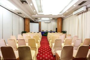 a room with rows of chairs and a screen at Grand Menteng Hotel in Jakarta