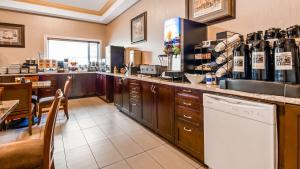a large kitchen with a counter and a restaurant at Best Western Williams Lake in Williams Lake