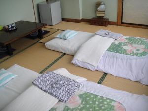 Postel nebo postele na pokoji v ubytování Ryokan Matsukaze