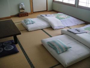 Postel nebo postele na pokoji v ubytování Ryokan Matsukaze