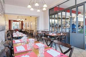 uma sala de jantar com mesas e cadeiras num restaurante em Pied à Terre Autun em Autun