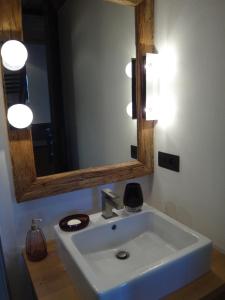 a bathroom with a white sink and a mirror at La Petite Suite in Megève