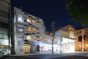 a building on a city street at night at Otaru YaDo in Otaru