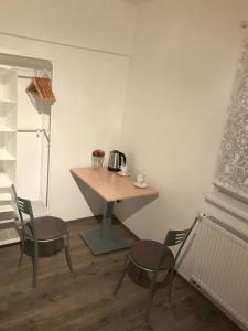 a small table and chairs in a room at Rooms Miki in Zagreb +12 photos