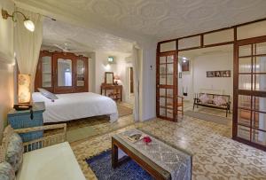 a bedroom with a bed and a living room at French Haveli in Ahmedabad
