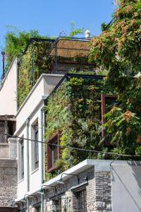 a building with plants on the side of it at The Foundry Suites in Athens