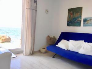 a blue couch in a living room with a window at Apartment Marina in Drasnice
