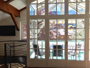 a large glass door with a view of a pool at Stanzl Haus in Kaltenbach
