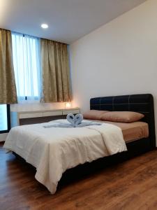 a bedroom with a bed with a blue bow on it at Vivacity jazz suite 3 condo 139 in Kuching