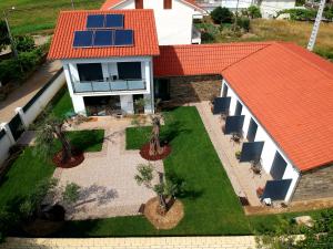 an aerial view of a house with solar panels on the roof at O Abel Hotel rural in Bragança