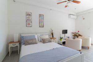 a bedroom with a bed with white walls and a ceiling at Adriana Holiday Apartment in Labin