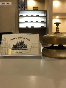a sign for the hotel concourses is next to a bell at Albergo Corvetto Corso Lodi in Milan