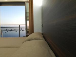 Postel nebo postele na pokoji v ubytování Hotel Ribera