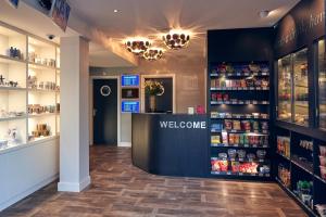 a store with a welcome counter and shelves of products at Singel Hotel Amsterdam in Amsterdam