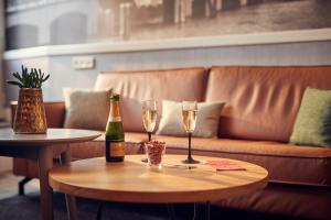 a table with two glasses and a bottle of champagne at Singel Hotel Amsterdam in Amsterdam