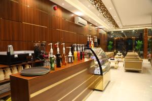 a restaurant with a counter with bottles of wine at Golden Rest Serviced Apartments in Al Khobar