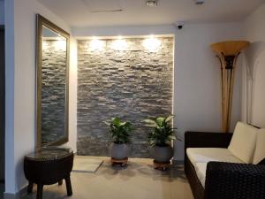 Una sala de estar con un sofá y una pared de piedra. en Hotel Zamay Gaira, en Santa Marta 31 fotos más