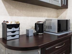 a kitchen counter with a microwave and a coffee maker at ArcadiaSky in Odesa