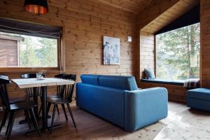 a dining room with a blue couch and a table at Bjørnfjell Mountain Lodge in Alta +60 photos