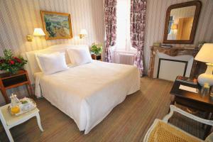 a hotel room with a large bed and a fireplace at Château De La Bourdaisière in Montlouis-sur-Loire