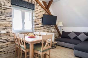 sala de estar con mesa, sillas y sofá en Ferienwohnung Zetzl, en Waidhaus