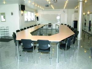 a conference room with a large table and chairs at Apartmenthaus "Zum Löwen" Heidelberg - Ziegelhausen in Heidelberg