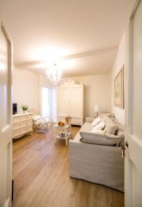 a white bedroom with a bed and a table at il risveglio di alice in Fano