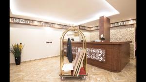 a bathroom with a towel rack and a counter at Janan Al Nakheel Serviced Apartments in Al Muzāḩimīyah