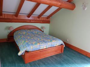 a bed with a wooden frame in a room at châlet in Ferdrupt