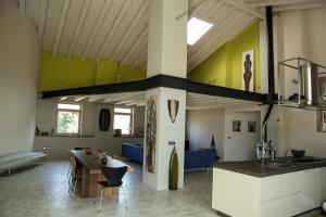 a kitchen and living room with a table and a couch at Un sogno che si avvera in Gorizia