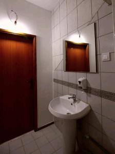 a bathroom with a white sink and a mirror at Apartments Astoria HN in Herceg-Novi