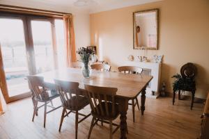 a dining room with a wooden table and chairs at Greenbank Bed & Breakfast in Montrose