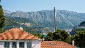 a house with a view of a bridge and mountains at Guest House Mrdalo in Dubrovnik