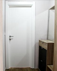 a white door in a room with a wooden cabinet at Apartments Astoria HN in Herceg-Novi +66 photos