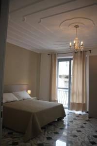 a bedroom with a bed and a chandelier at Il Ravot in Druento