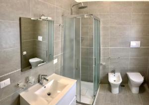 a bathroom with a shower and a sink and a toilet at B&B Baronia Luxury Rooms in Castel Baronia +56 photos
