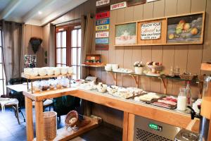 a bakery with a counter with food on it at Domaine Utah Beach - Le Grand Hard in Sainte-Marie-du-Mont
