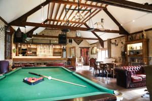 a living room with a pool table in it at Domaine Utah Beach - Le Grand Hard in Sainte-Marie-du-Mont