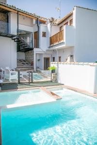einen Pool im Hinterhof eines Hauses in der Unterkunft Apartamentos Turísticos La Casa Vieja in Sabiote