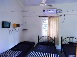 Postel nebo postele na pokoji v ubytování Stay Goa Guesthouse