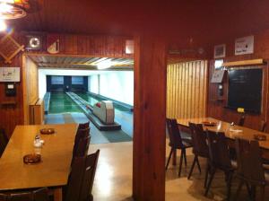 a dining room with a pool table and a bowling alley at Gasthof Richebächli in Elzach