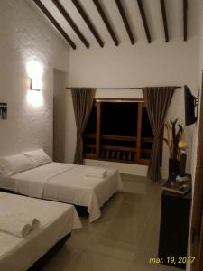 Postel nebo postele na pokoji v ubytování Finca Hotel Guali Santafe