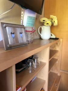 a shelf with hearts on it with a vase of flowers at Camera Alpe di Siusi in Alpe di Siusi