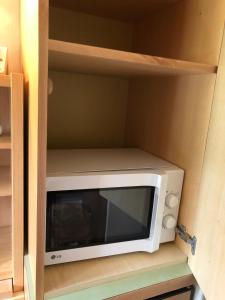 a microwave sitting inside of a kitchen cabinet at Camera Alpe di Siusi in Alpe di Siusi