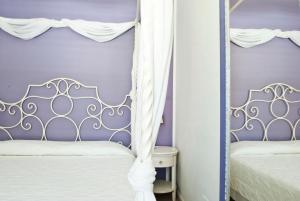Postel nebo postele na pokoji v ubytování Hotel Mea - Aeolian Charme