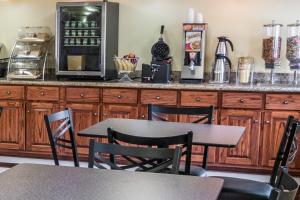a table and chairs in a kitchen with a counter at Days Inn by Wyndham Houston in Houston
