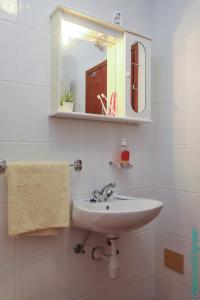 a white bathroom with a sink and a mirror at Ribarica GO green in Ribarica +46 photos