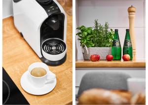 a coffee maker and a cup of coffee on a table at Prestige Apartaments 79 in Wrocław