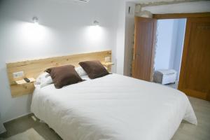 Cama o camas de una habitación en Apartamentos Turísticos La Casa Vieja